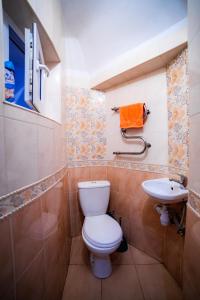 a bathroom with a toilet and a sink at A1 Hostel in Lviv