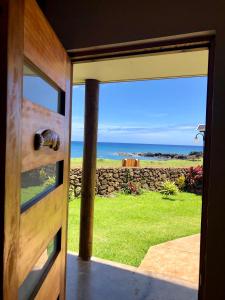 a door to a room with a view of the ocean at Cabañas Anavai Rapa Nui in Hanga Roa