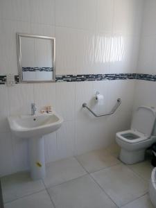 a bathroom with a sink and a toilet at Eros Guest Inn in Francistown
