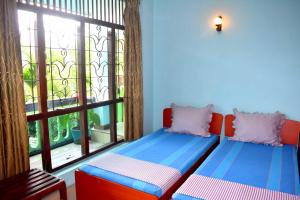 Ένα ή περισσότερα κρεβάτια σε δωμάτιο στο Rathna Gems Halt