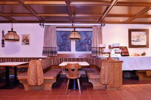 a restaurant with a couch and tables and a table at Residence Terentis in Terento