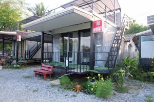 a tiny house with a red bench in front of it at Sida Homemade in Chiang Khan