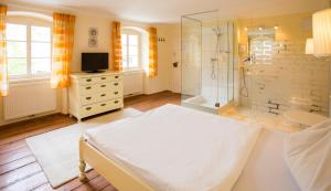 a large bathroom with a bed and a shower at Hotel Brummeier in Eferding