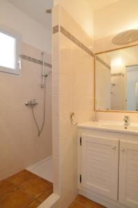 a bathroom with a shower, sink, and tub at Résidence Les Hameaux de Santa Giulia in Porto-Vecchio