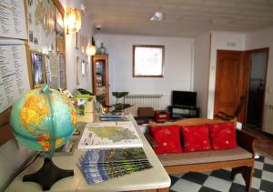 a room with a table with a globe and a couch at Hostal Fonda Prat in Puigcerdà