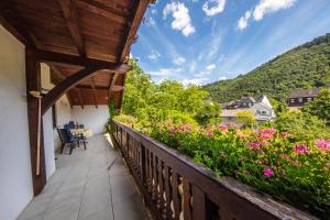 a balcony with a view of flowers and mountains at Ferienhaus "Anne" und Weingut Willi Fett in Ellenz-Poltersdorf