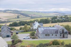 an aerial view of a house with a car parked in front at Dolphin View Hillockhead in Rosemarkie