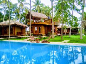 a villa with a pool in front of a resort at Rice Rice Villas in Tissamaharama