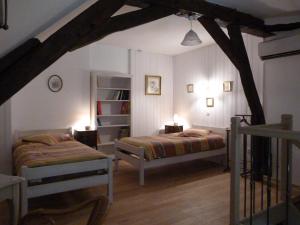 Ένα ή περισσότερα κρεβάτια σε δωμάτιο στο Le Petit Gite De La Promenade