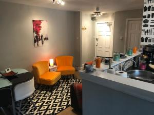 a kitchen with orange chairs and a sink at Central city 1 bed apartment in Bath