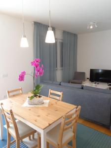 a living room with a wooden table with flowers on it at Sun with Style in Figueira da Foz