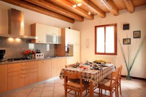 a kitchen with a table and chairs and a kitchen with at CASA GIULIA a Borso del Grappa in Borso del Grappa