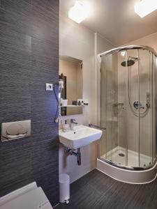 a bathroom with a sink and a shower at Boutique Hotel Chrysso in Košice