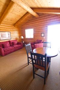
a living room with a couch, chairs and a table at Cody Cowboy Village in Cody
