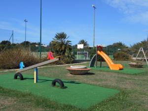 a park with several slides and a playground at Le Case Punta Negra in Stintino