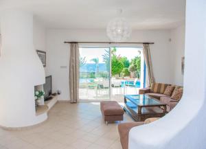 a living room with a couch and a table at Luxury holiday villa Apollo 9 in Paphos