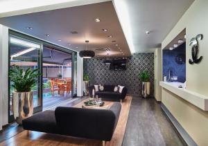 a living room with a couch and a table at Boutique Hotel Chrysso in Košice