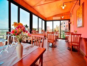 a restaurant with tables and chairs with flowers on them at Hotel Ristorante Garibaldi in Frosinone