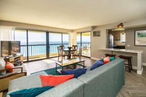 a living room with a couch and a view of the ocean at Aston Waikiki Beach Tower in Honolulu