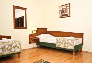 A bed or beds in a room at Hotel Klastrom