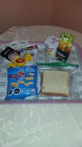 a table with a sandwich and other food on it at Hotel Don Alfredo in Calama