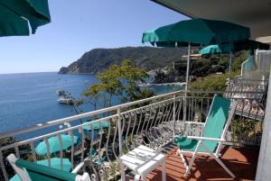 a balcony with chairs and a view of the ocean at Hotel Porto Roca in Monterosso al Mare