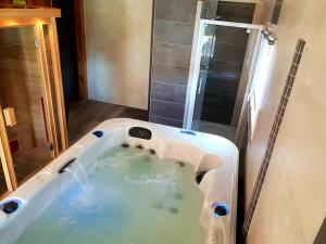 a bath tub in the middle of a bathroom at D&O - Guesthouse - "la Pinède" in Saint-Gérons