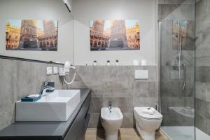 a bathroom with a sink and a toilet and a shower at San Petronio Central Studio in Bologna +5 photos