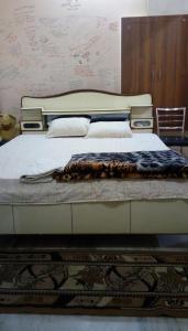 a large bed in a room with at Sunita homestay in Agra
