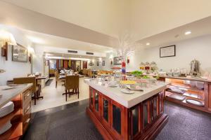 a kitchen and dining room with a table with food at La Dolce Vita Hotel in Hanoi