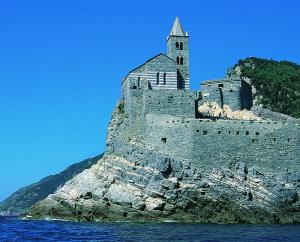 a castle on top of an island in the water at finestra tra cielo e mare in Luni