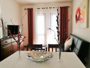 a dining table with two vases and a bowl on it at FN FUNCHAL Tenerife 101 in El Guincho +5 photos