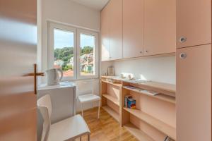 a small kitchen with a window and a desk at Ivkolina in Hvar