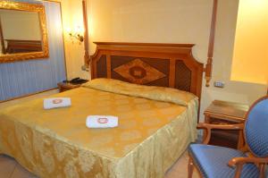 a hotel room with a bed and a table at Hotel Il Principe in Milazzo