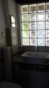 a bathroom with a sink and a window at TIA casa vacanza in Bevagna