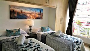 Postel nebo postele na pokoji v ubytování Playa de Las Americas Sea Views + 11 fotografií