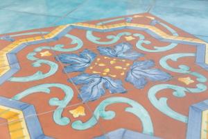 un pavimento piastrellato con un design floreale. di Sebeto Bellini a Napoli