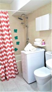 a bathroom with a toilet and a shower curtain at Las Americas Panoramic Ocean Views in Playa de las Americas