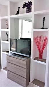 a living room with a tv on a entertainment center at Las Americas Panoramic Sea Views in Playa de las Americas