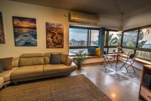 a living room with a couch and a table at Desert Picture in Arad