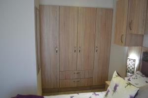 a bedroom with a large wooden cabinet next to a bed at The Balmoral Caravan in Dornoch