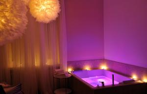 a lit up bathroom with a lit up bathtub at Le Gourguillon in Lyon