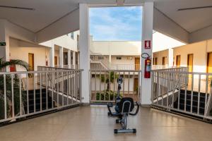 um corredor hospitalar com uma cadeira no meio de um edifício em Vila Real Hotel em Porto Nacional