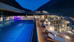 a swimming pool on the side of a building at Amonti Wellnessresort in Cadipietra +53 photos