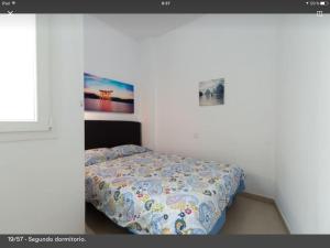 A bed or beds in a room at Apartamento Playa Las Canteras
