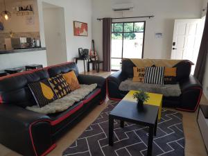a living room with two couches and a table at Luxury Villa @ A'F Resort in Melaka