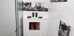 a bathroom with a shower with a toilet and a picture at Palm beach Cannes Azur in Cannes