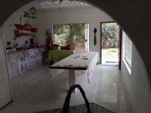 a kitchen with a table in the middle of a room at Finca la Miradita in Cumaral