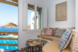 a living room with a couch and a table at Summer Lovers Villa in Akrotiri