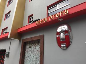 a hotel entrance with a car on the side of a building at Hotel H - Arena Adults Only in Mexico City